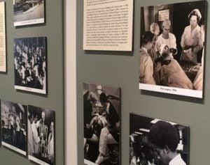 Historical photographs on museum wall. 