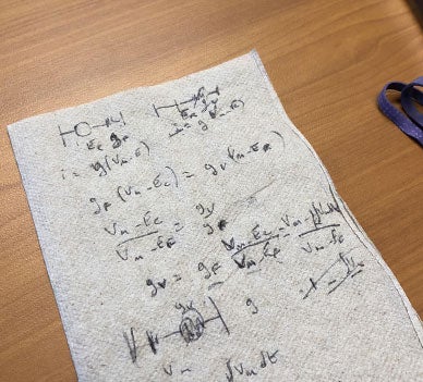 A napkin on the desk of professor Dominique Durand showing Equations which are part of Durand's most recent work.