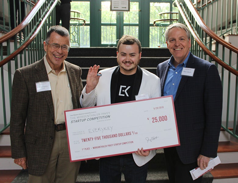 Pitch competition winner Chris Wentz holding a large check and Ray Leach posing for photo with Bob Pavey and