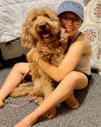 Photo of Emily Eckermann hugging her dog