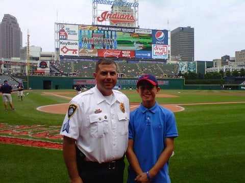 Detective Sgt. Daniel Schemmel, spending Father's Day with his teenage son at the Cleveland Indians game