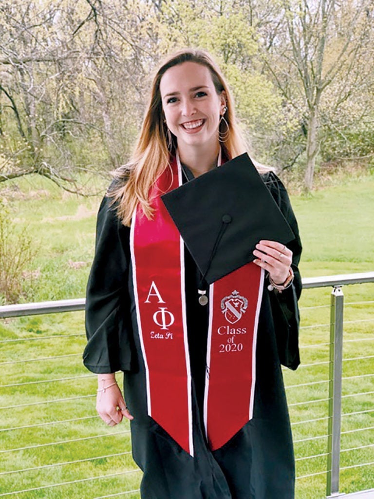 2020 Case Western Reserve alumna Grace Moran holding a graduation cap at her home in Chicago