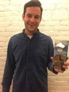 Brian Tighe holding one of his magnetic bottle openers.