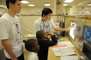 Dental Medicine students show children x-rays