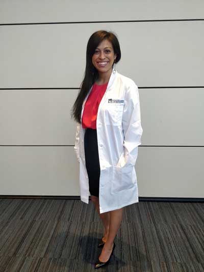 Case Western Reserve University dental student Lizzeth Moreno standing, wearing a white coat