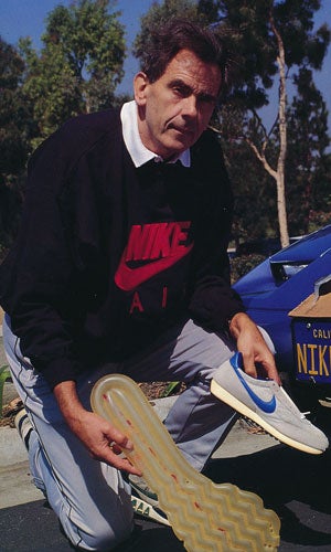 Photo of M. Frank Rudy holding his Nike Air Sole invention.