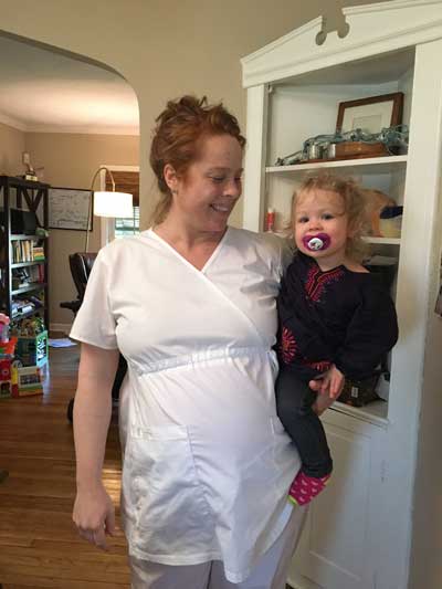 Case Western Reserve University student Magdelana Larson holds her toddler daughter