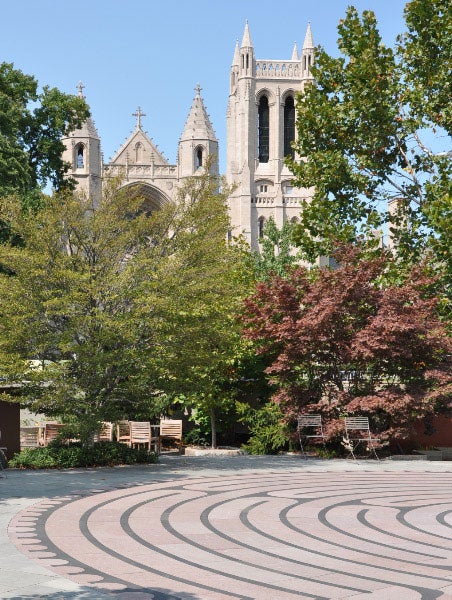 Photo of the McGaffin Tower with the labyrinth in the Schneider Healing Garden in the foreground