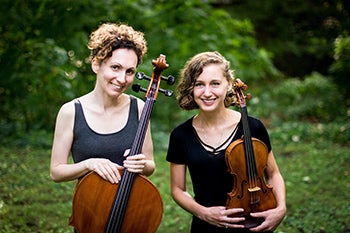 Two female musicians holding string instruments