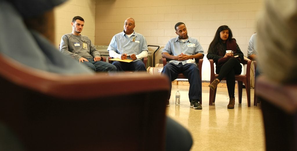 CWRU students sitting alongside Lorain County Correctional Institute inmates