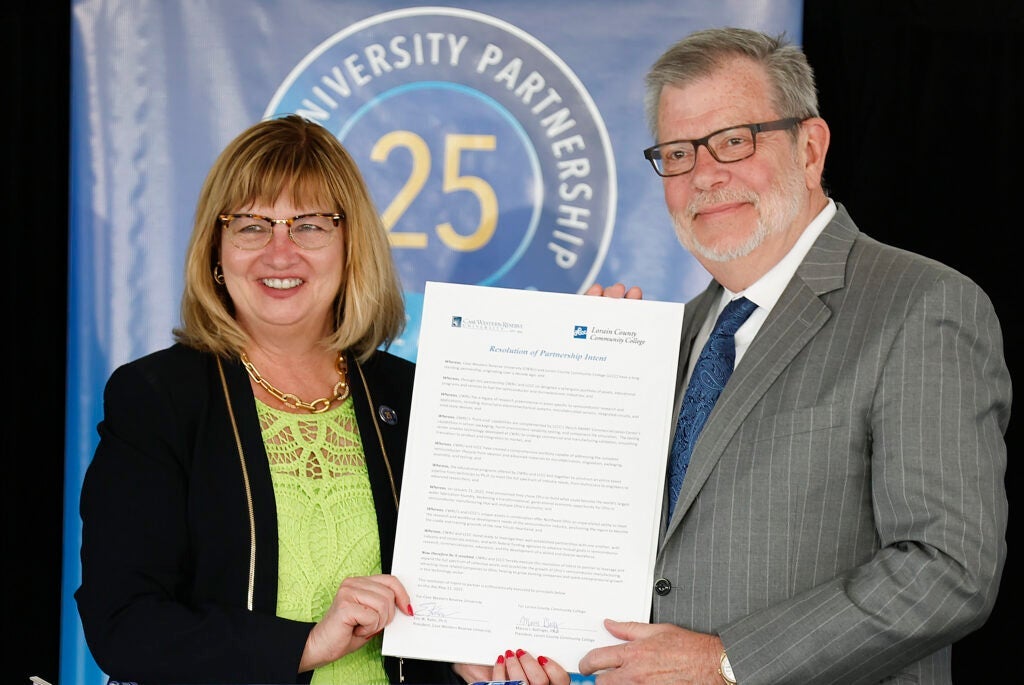 LCCC President Marcia J. Ballinger and Case Western Reserve University President Eric W. Kaler show off the signed Resolution of Partnership Intent.