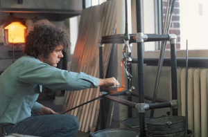Artist working on glass blown art