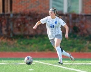 Sydney Schenk kicking ball during soccer game