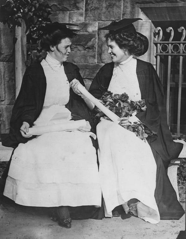 A pair of graduates holding their diplomas in 1910.