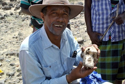 Yohannes Haile-Selassie, holding a cranium fossil