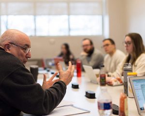 teacher talks with students in a classroom