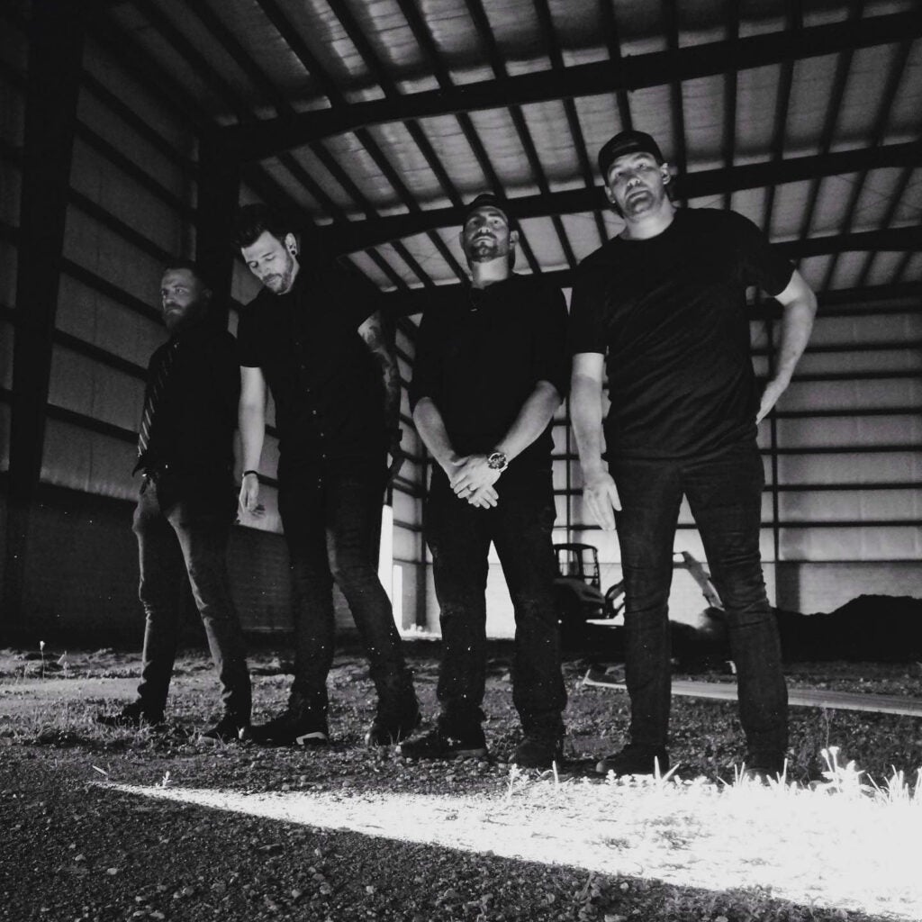 Black and white photo of four members of the Bad Hooks band