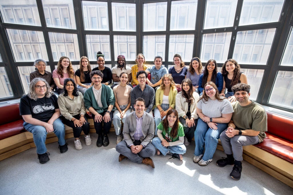 Photo of Ben Clayton posing for a photo with members of his lab