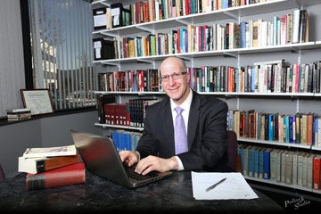 Photo of Brian Amkraut sitting at a desk and typing