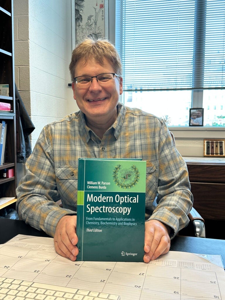 Photo of Clemens Burda holding his text book