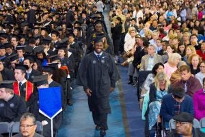 Graduates walk down aisle at commencement
