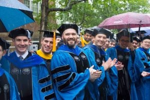 Graduates facing rainy conditions at commencement