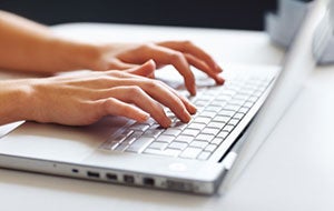 woman typing on keyboard