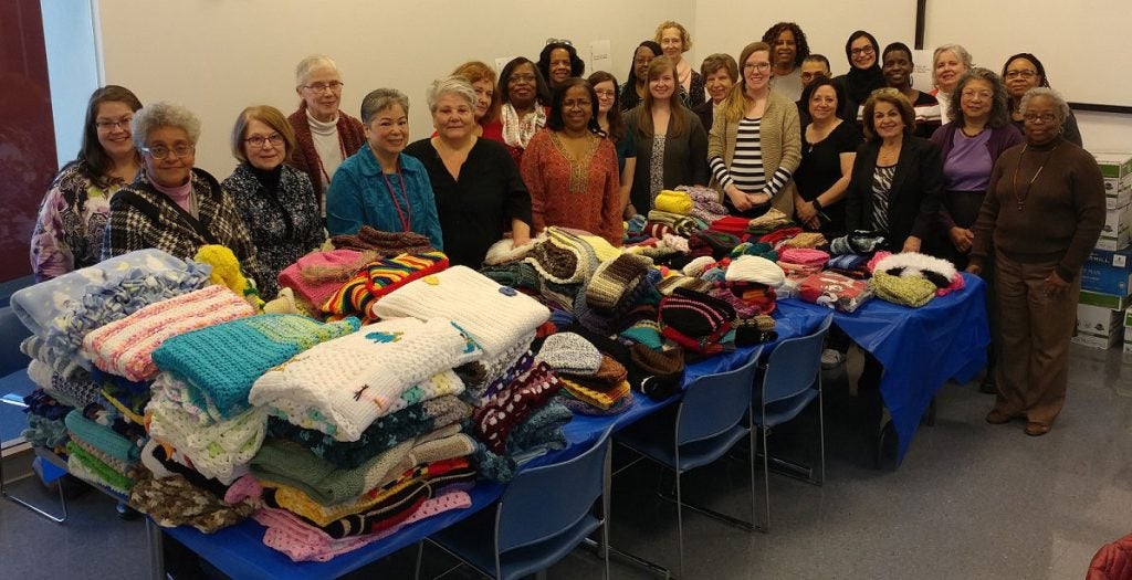 Members of the Crafters@Case group pose with items they made
