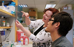 Colleen Croniger and a student in a lab