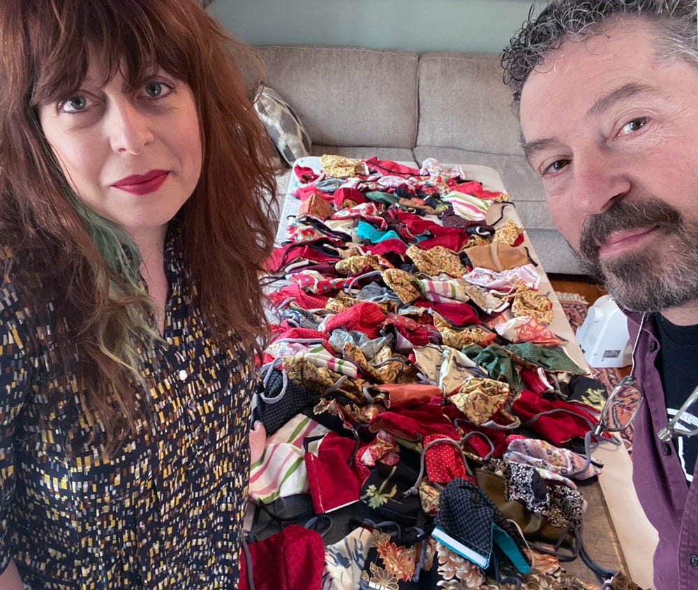 Sarah Curry and David King pose for photo with masks they've made