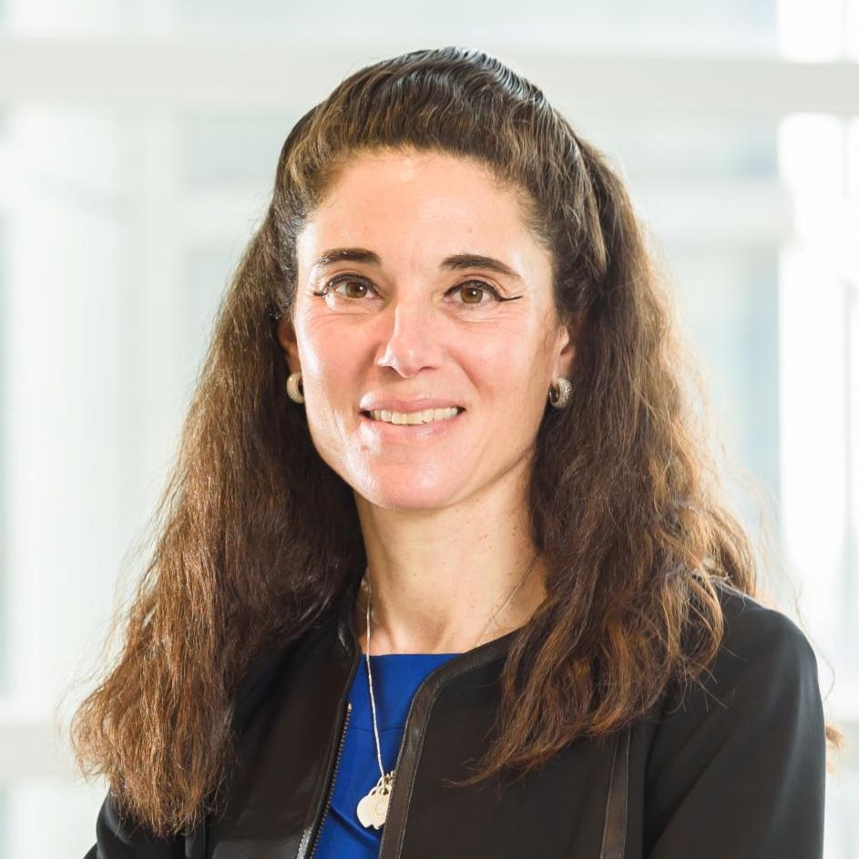 Portrait of Jill Barnholtz-Sloan in blue dress and black blazer