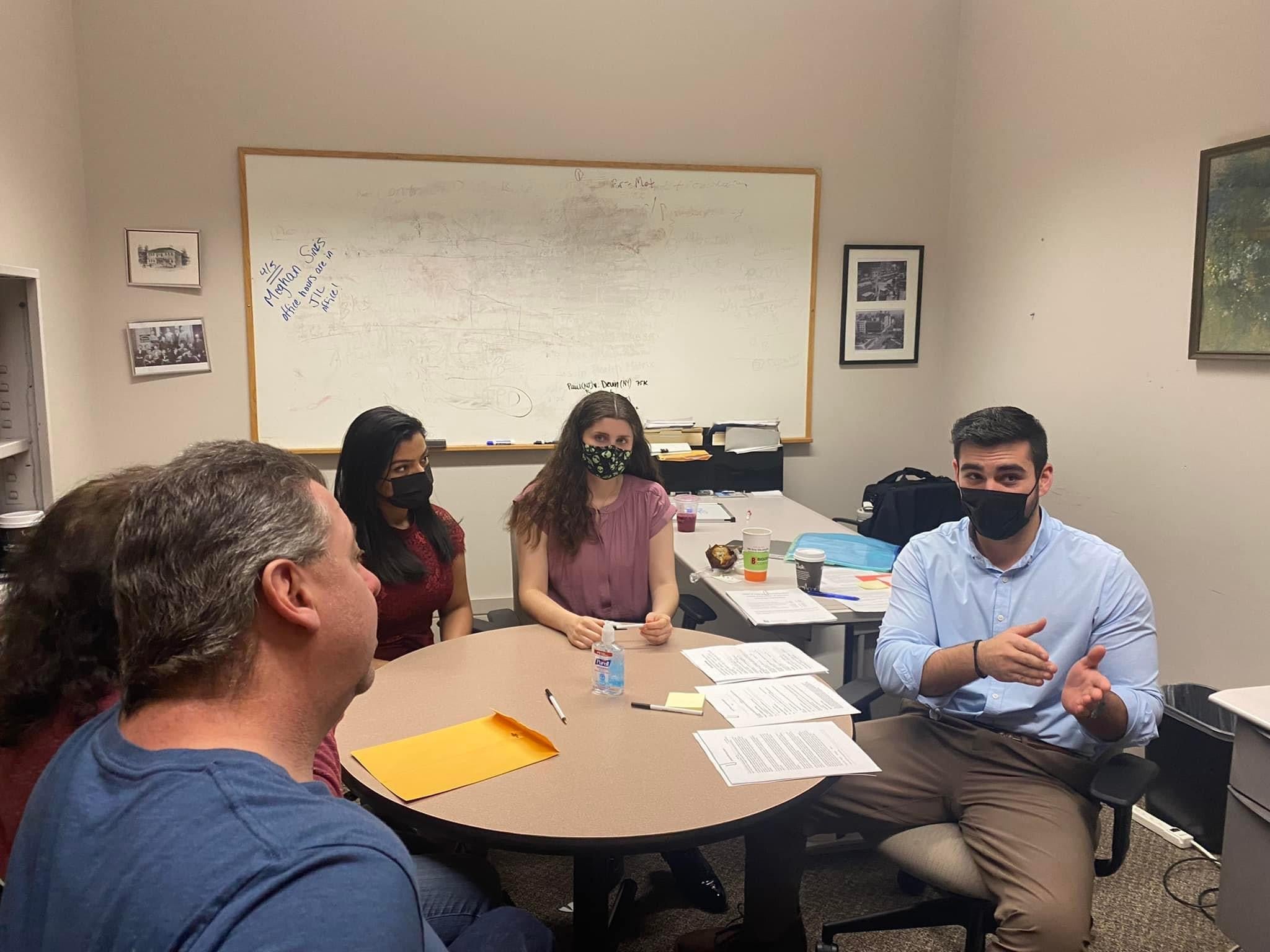 four people sit around a table to discuss wills