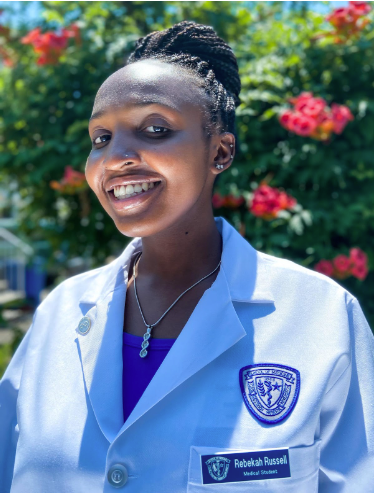 Rebekah Russell standing outside with white coat