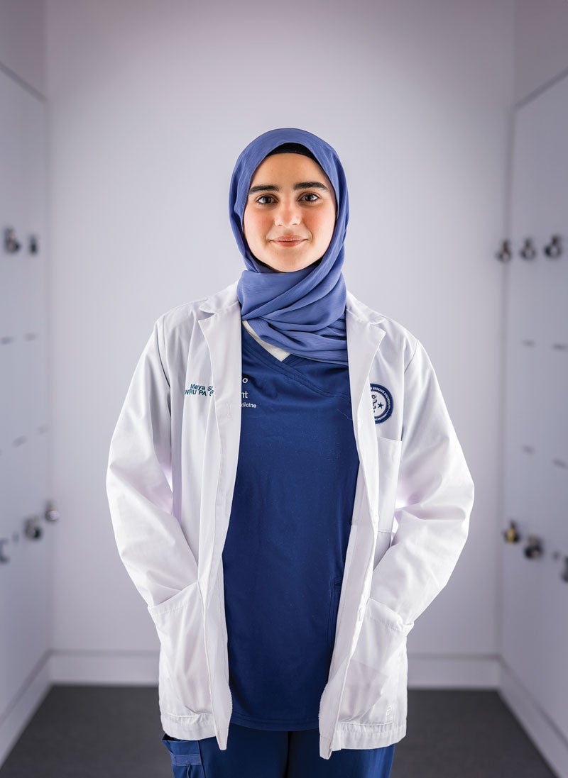 Case Western Reserve University School of Medicine student Maya Sinjo poses in a white coat