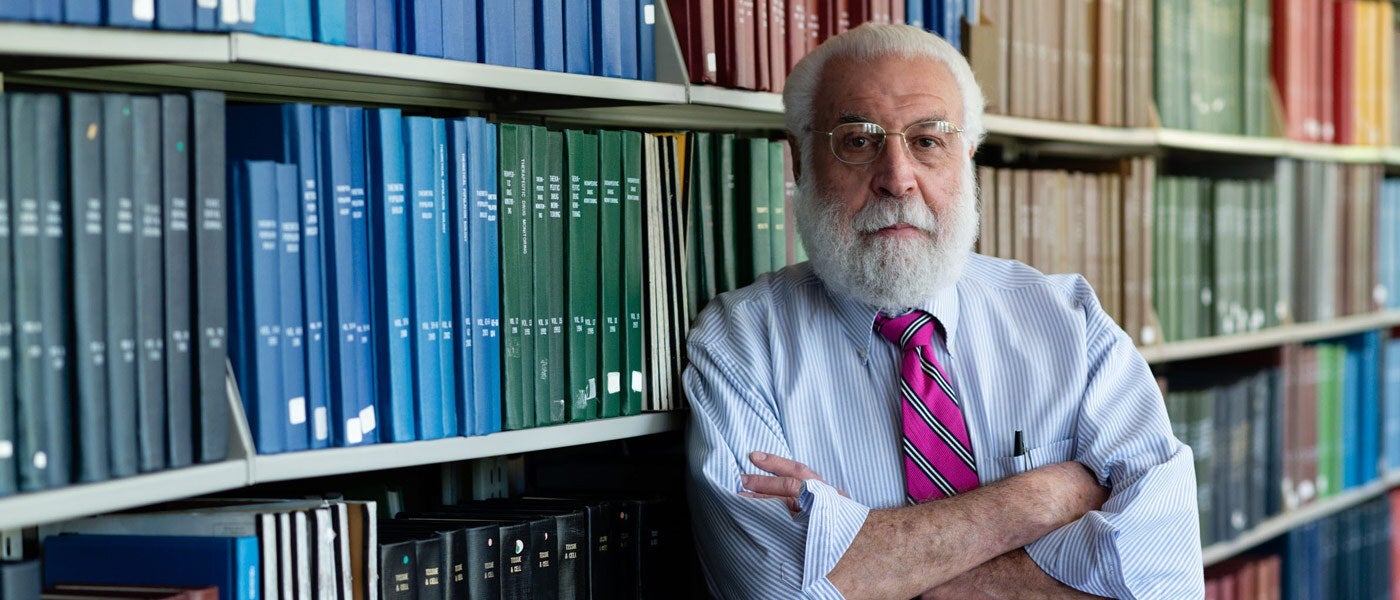 Photo of Nate Berger in front of a bookcase
