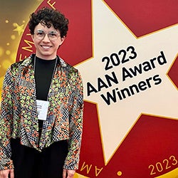Trenley Anderson with sign that reads 2023 AAN Award Winners