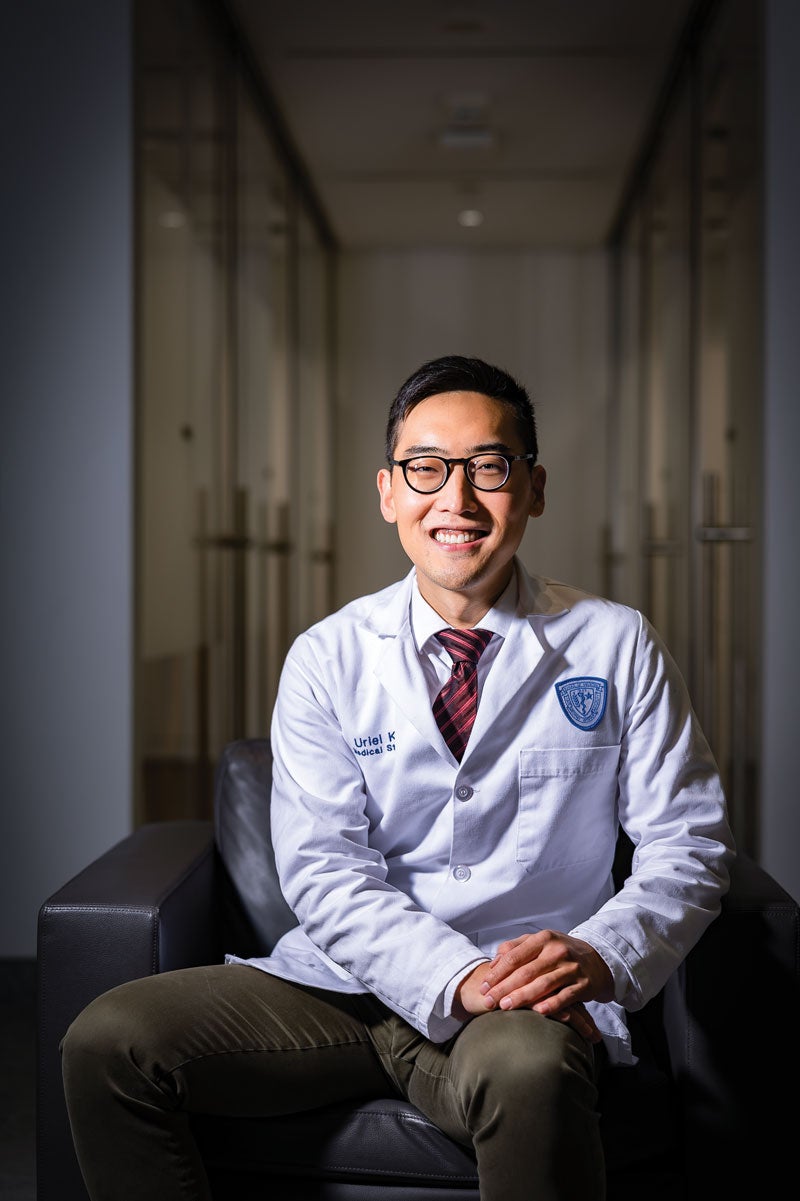 Case Western Reserve University School of Medicine student Uriel Kim poses in a white coat