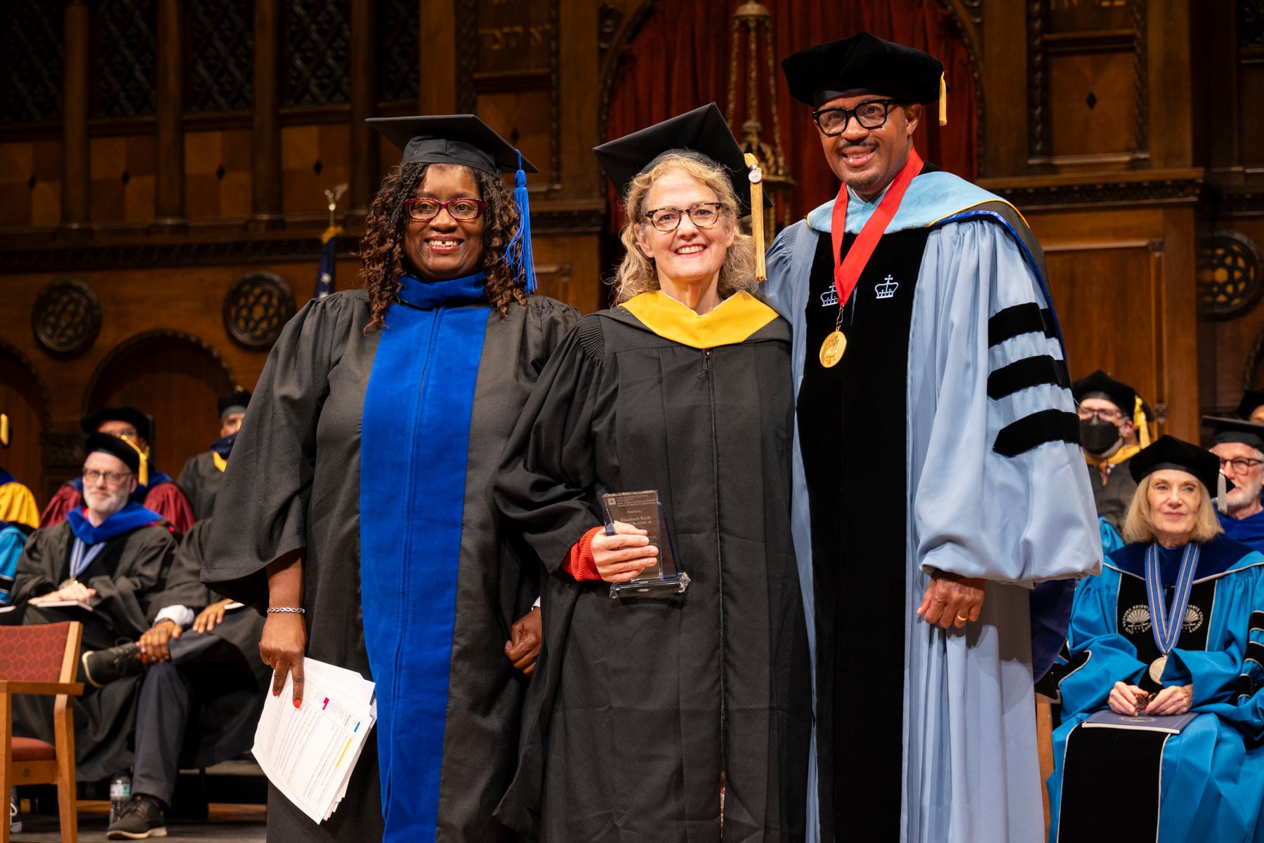 Elizabeth Bach accepts her award from Dean Voisin and Adriennie Hatten