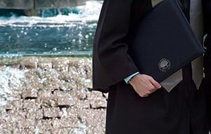 man holding CWRU diploma
