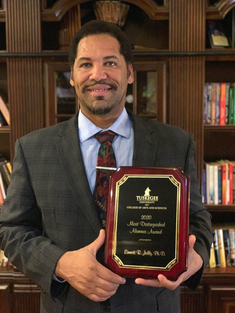 Emmitt Jolly holding a plaque