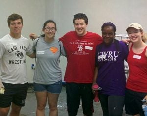 Gabriella Kaddu and four other students pose for photo while volunteering.