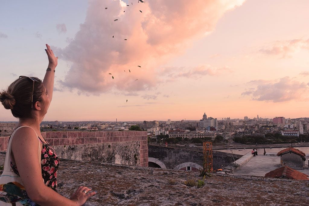 Student overlooking the the city of Havana at sunset