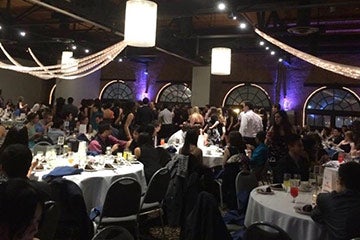 Photo showing students seated at tables during the Graduate Student Appreciation Week Ball