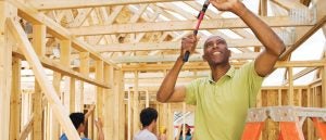 A guy working on framing a house