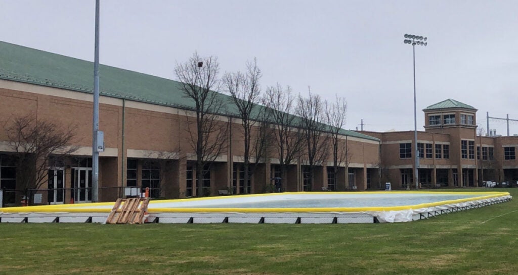 Photo of an ice rink on Van Horn Field with the Veale Convocation, Recreation and Athletic Center in the background