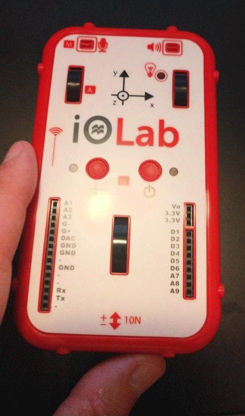 Photo of someone holding a device called an iOLab