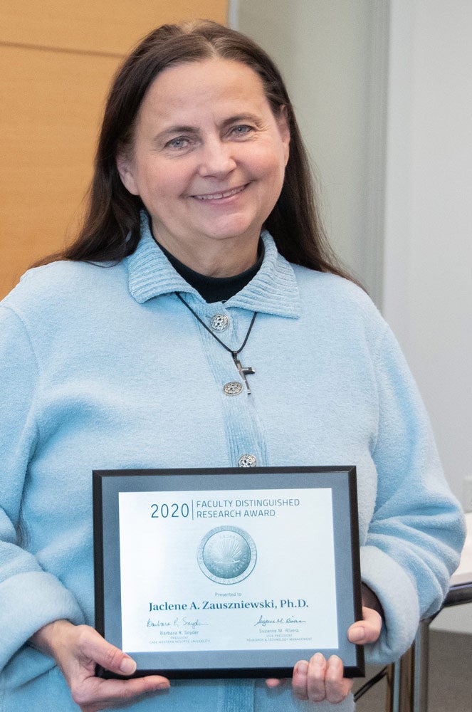 Photo of Jaclene A. Zauszniewski holding an award plaque