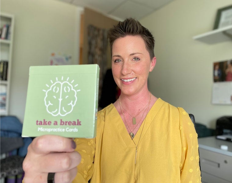 Photo of Jennifer King and her deck of Take a Break micropractice cards.