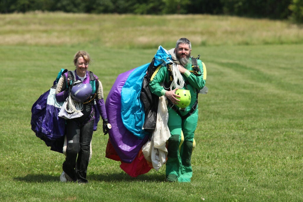 Photo of Jim Nauer and Heidi Wagner walking after a skydive jump