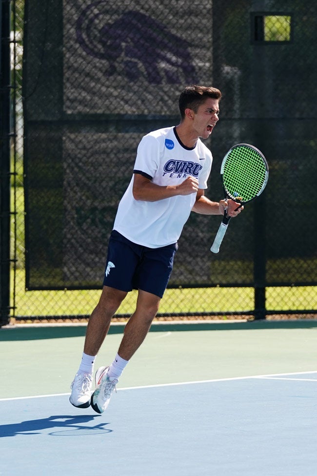 Photo of Jonathan Powell on the tennis court celebrating